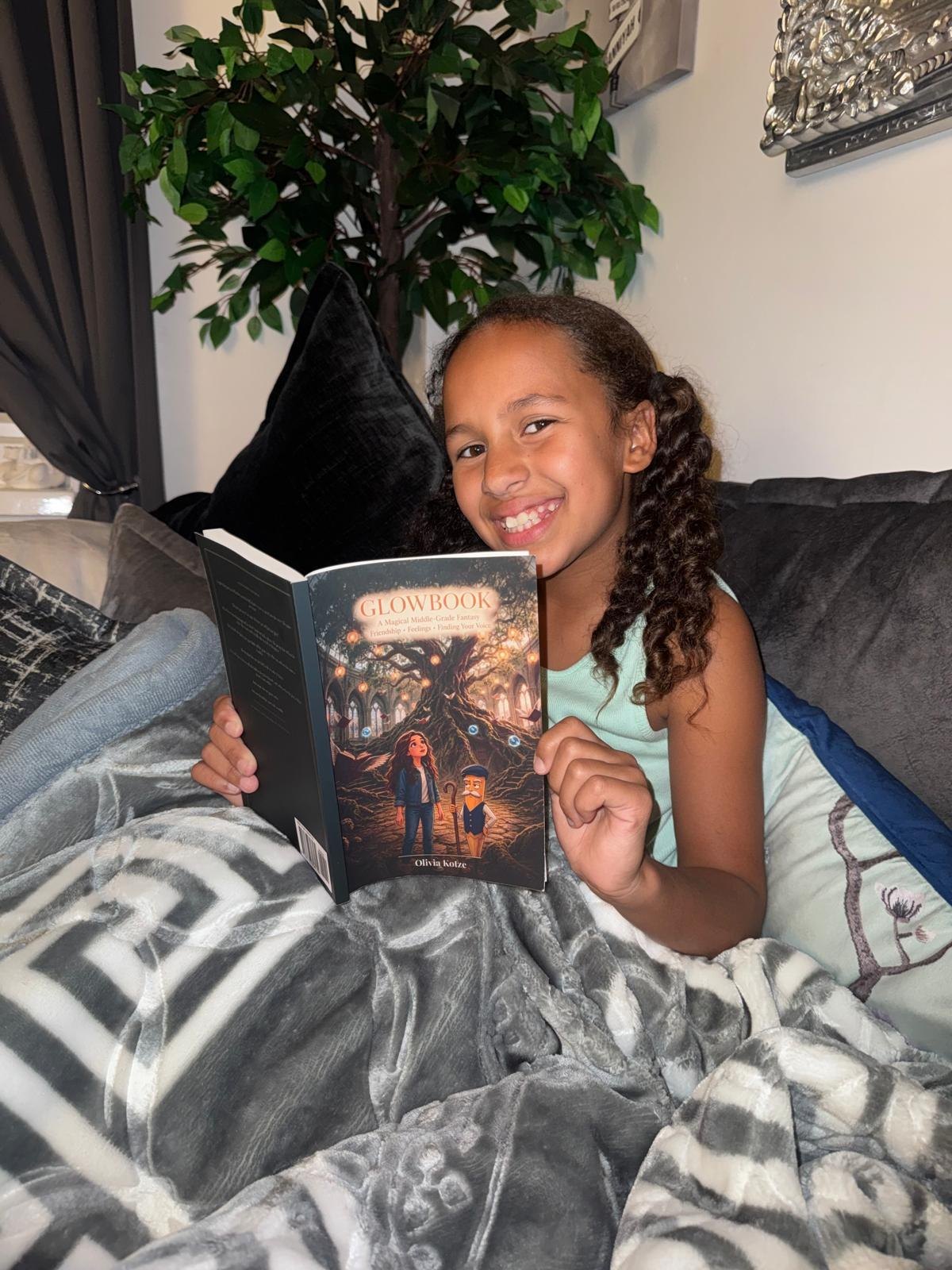 A girl reading GlowBook on the sofa.